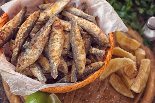 Fish and chips on wooden table with copy space