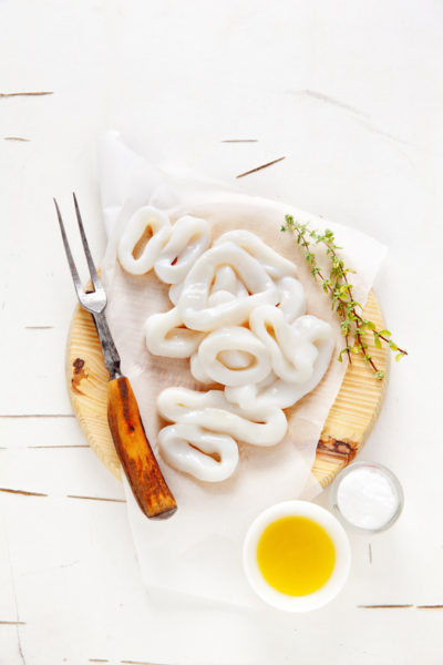 sliced raw squid rings with lime, olive oil, breadcrumbs. Preparation of  Summer  healthy snacks